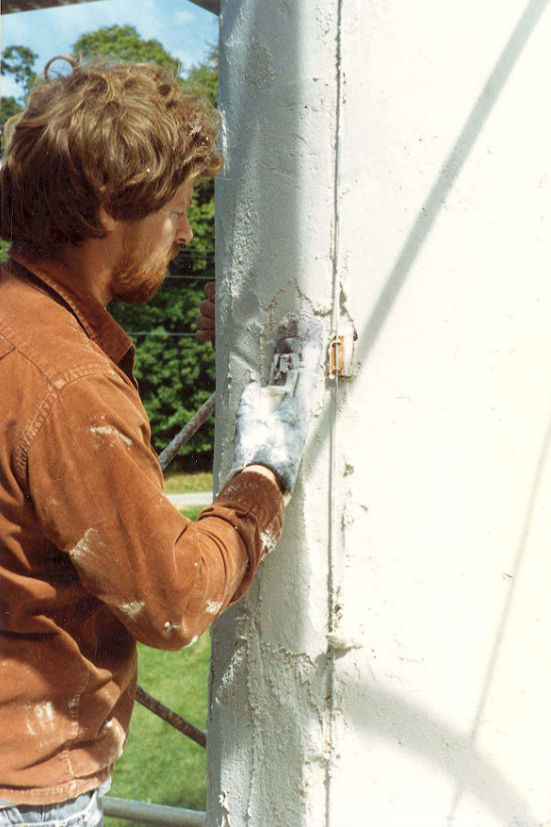 Applying stucco to the column shafts